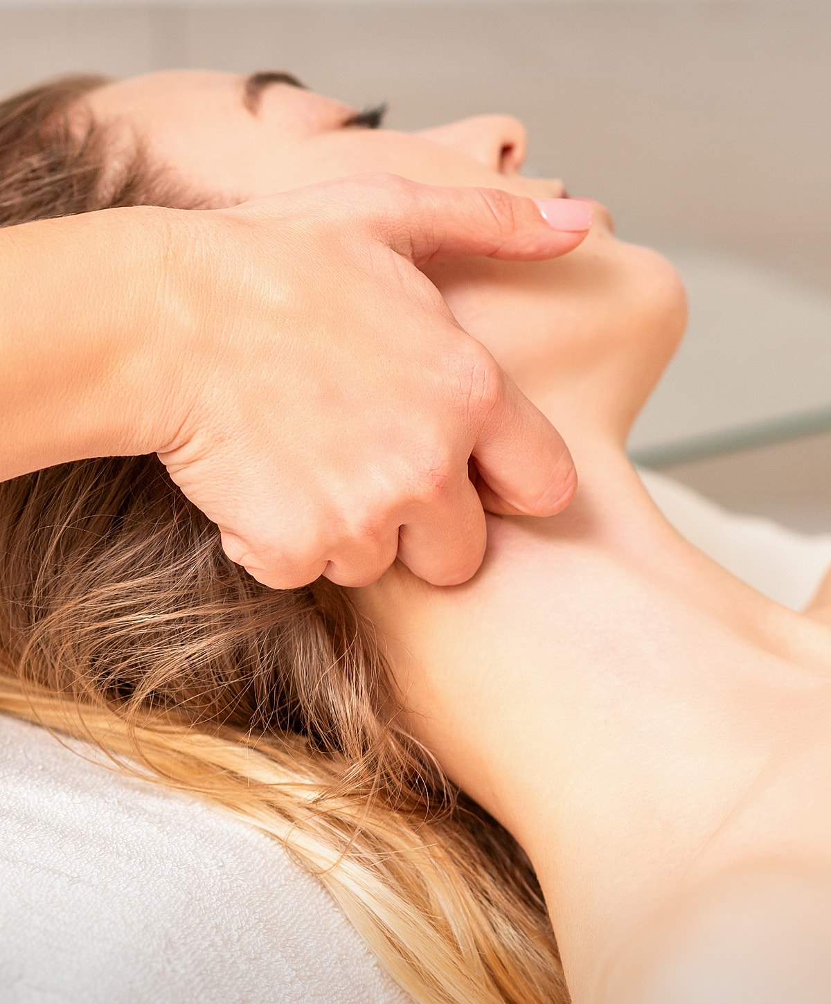 Relaxing neck massage in a serene setting.