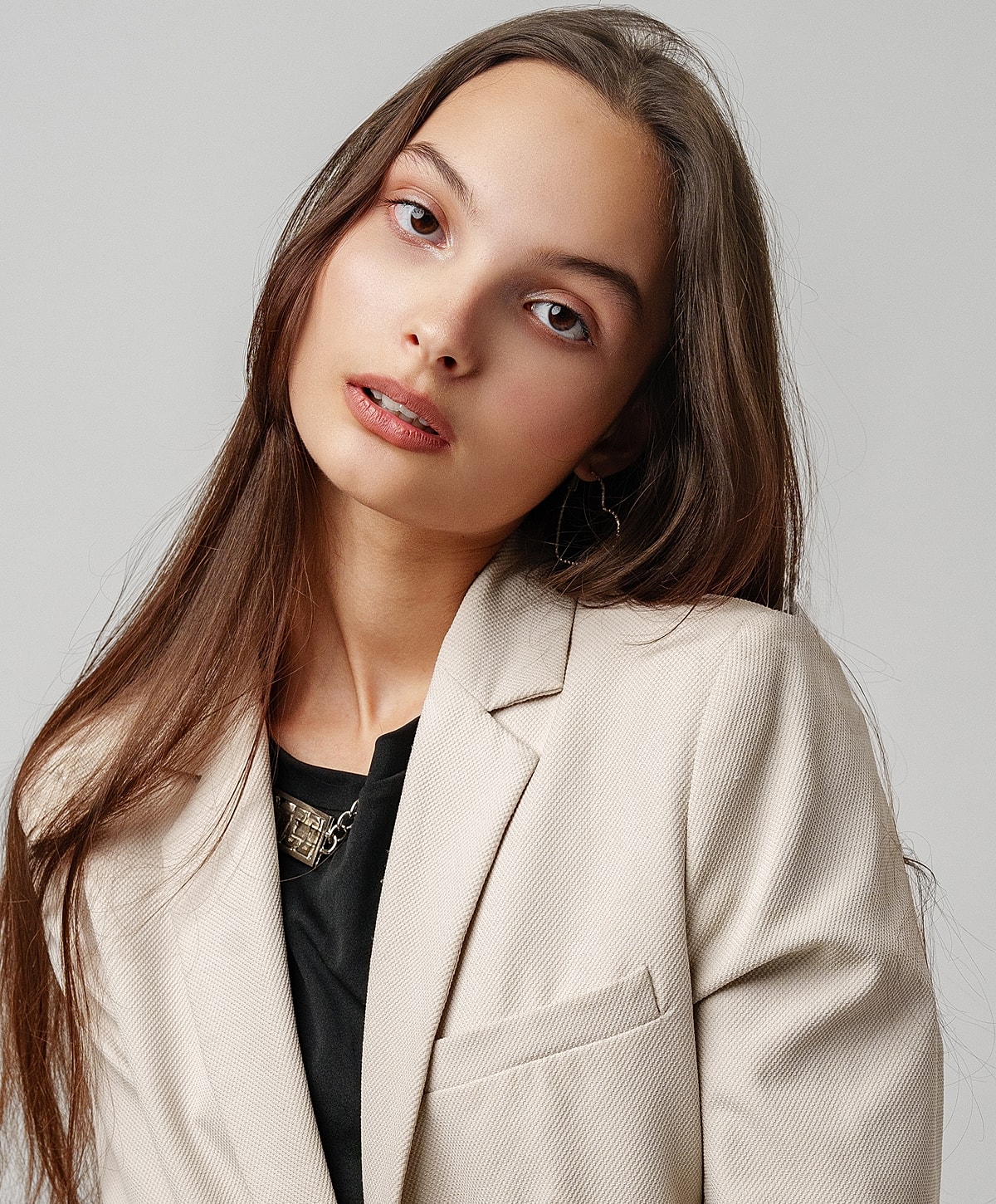 Smiling woman with long wavy hair in robe.
