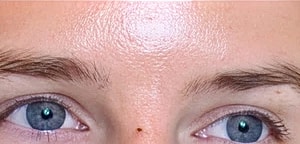 Close-up of blue eyes and forehead.