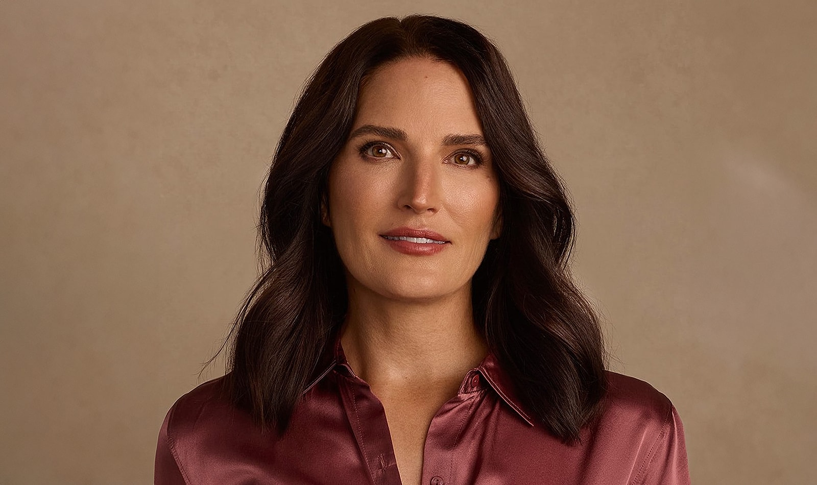 Portrait of a woman in a burgundy blouse.